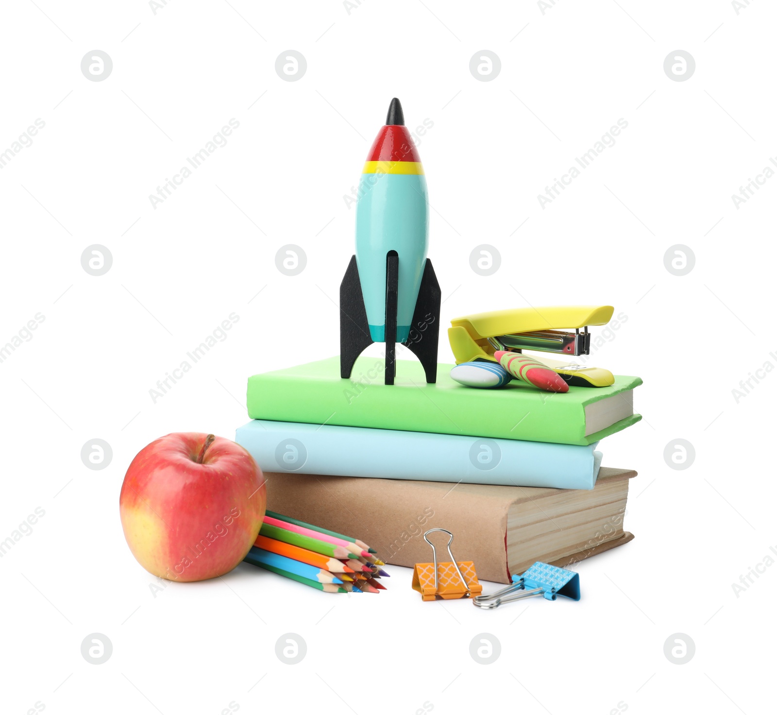 Photo of Bright toy rocket and school supplies on white background