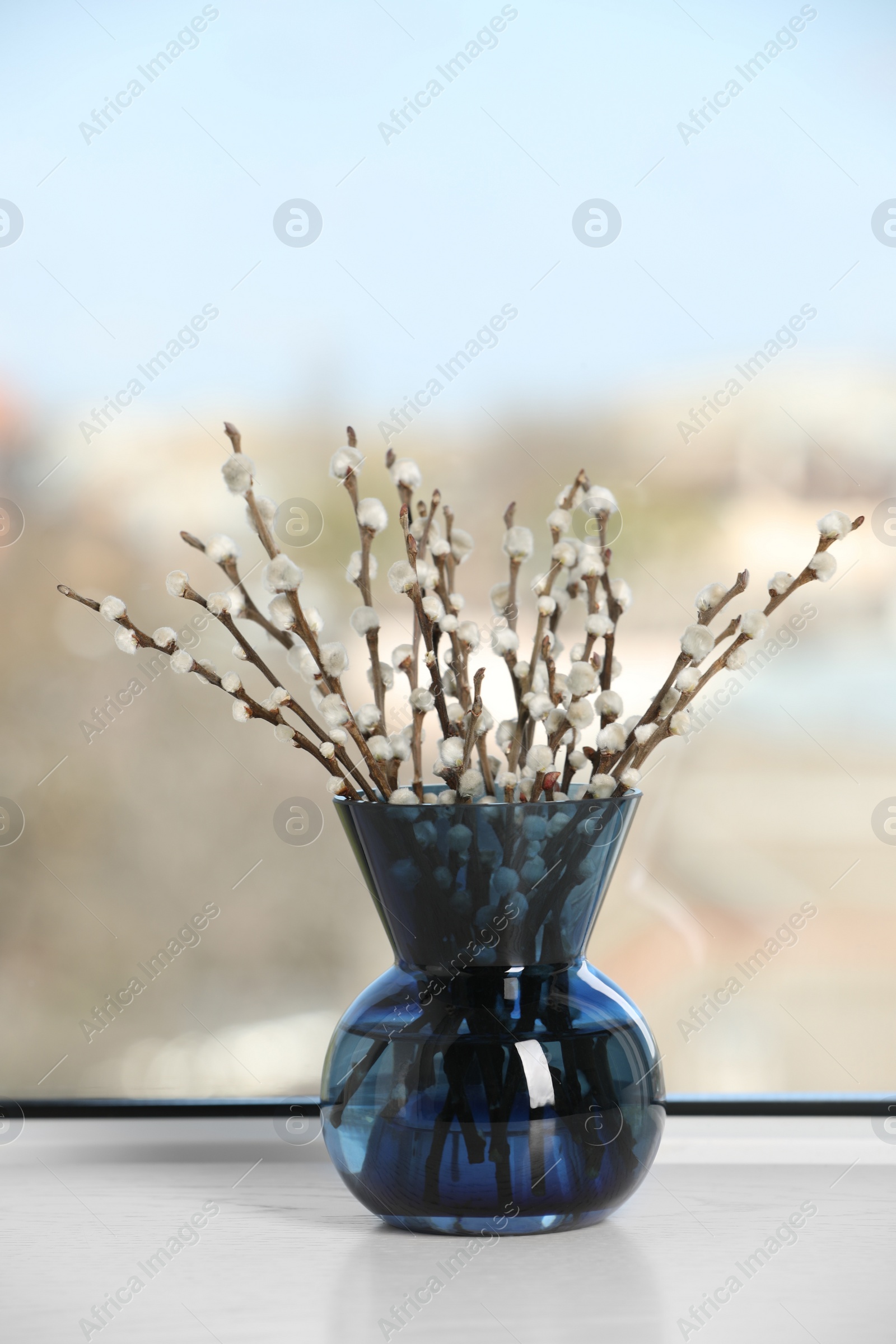 Photo of Beautiful pussy willow branches in vase on window sill