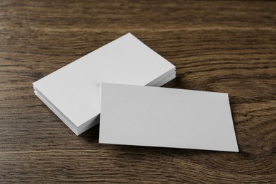 Photo of Blank business cards on wooden background. Mockup for design