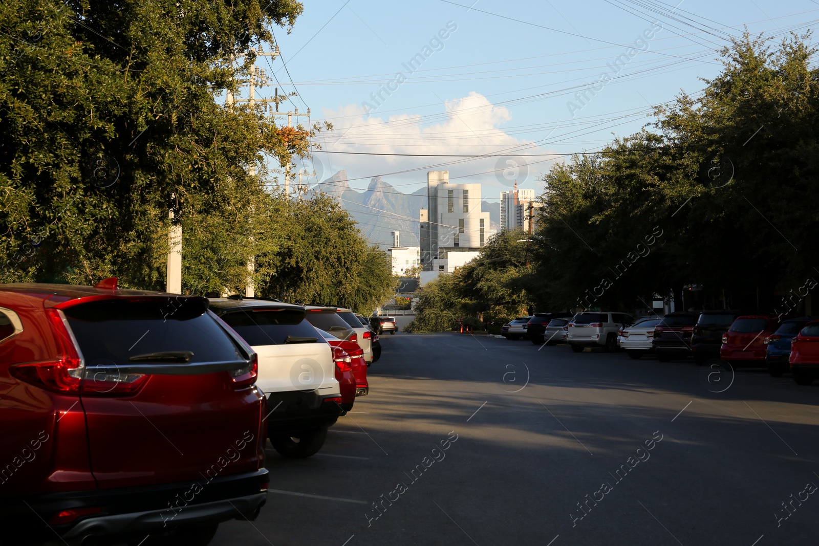Photo of Picturesque view of city street with cars on road near beautiful buildings