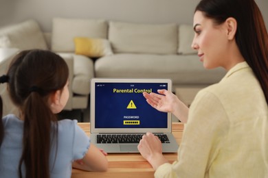 Photo of Mother installing parental control app on laptop to ensure her child's safety at home