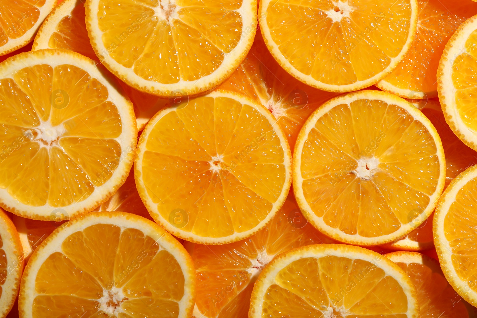 Photo of Slices of juicy orange as background, top view