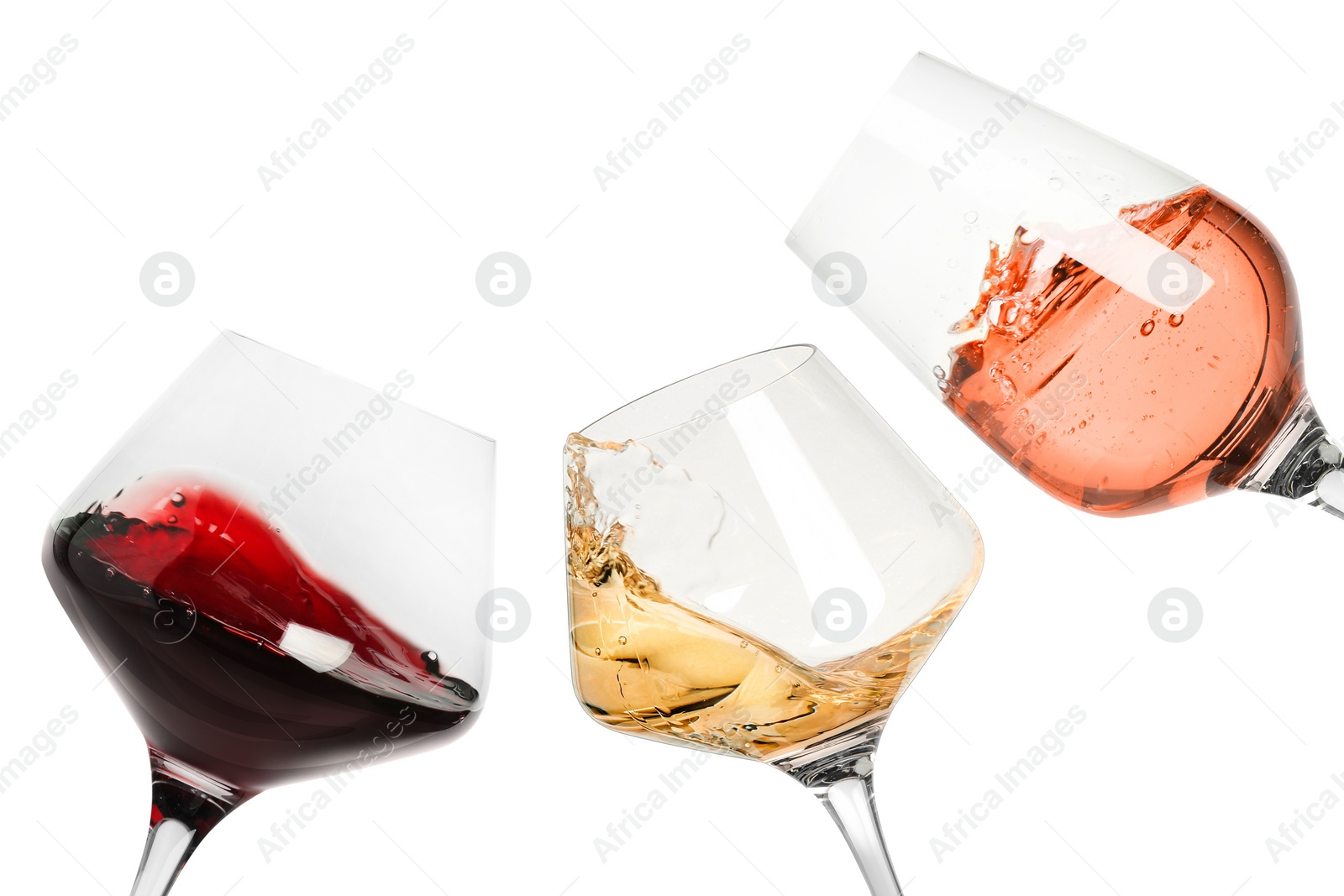 Image of Different types of wine splashing in glasses on white background