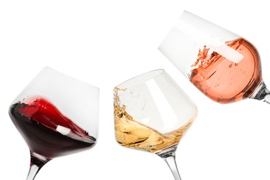 Image of Different types of wine splashing in glasses on white background