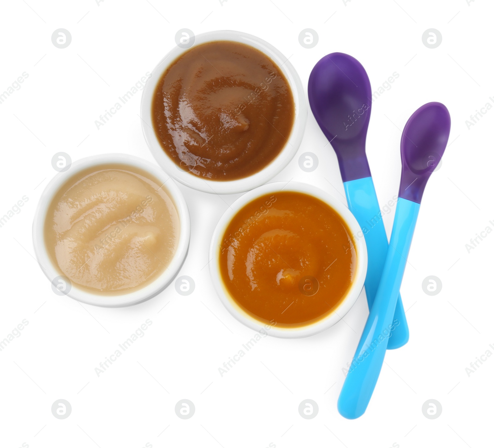 Photo of Bowls with healthy baby food and spoons isolated on white, top view