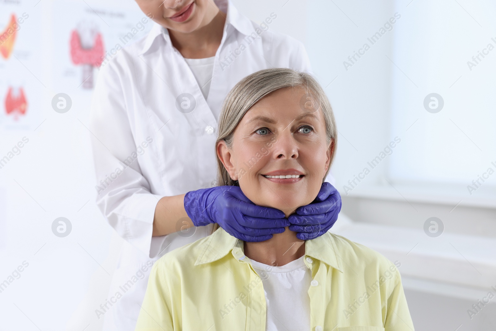 Photo of Endocrinologist examining thyroid gland of patient at hospital, closeup