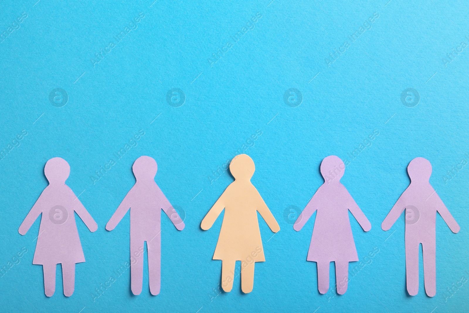 Photo of Many different paper human figures on light blue background, flat lay with space for text. Diversity and inclusion concept