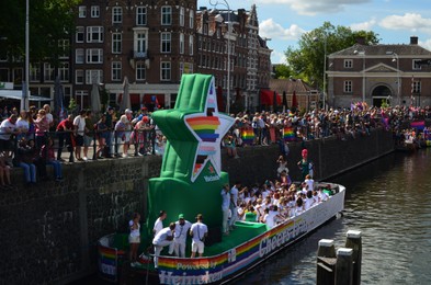 AMSTERDAM, NETHERLANDS - AUGUST 06, 2022: Many people in boat at LGBT pride parade on river