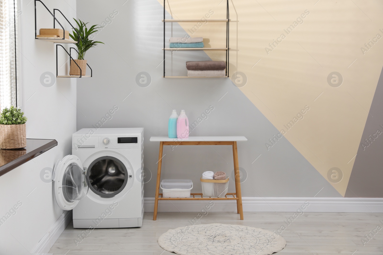 Photo of Modern washing machine in laundry room interior. Space for design