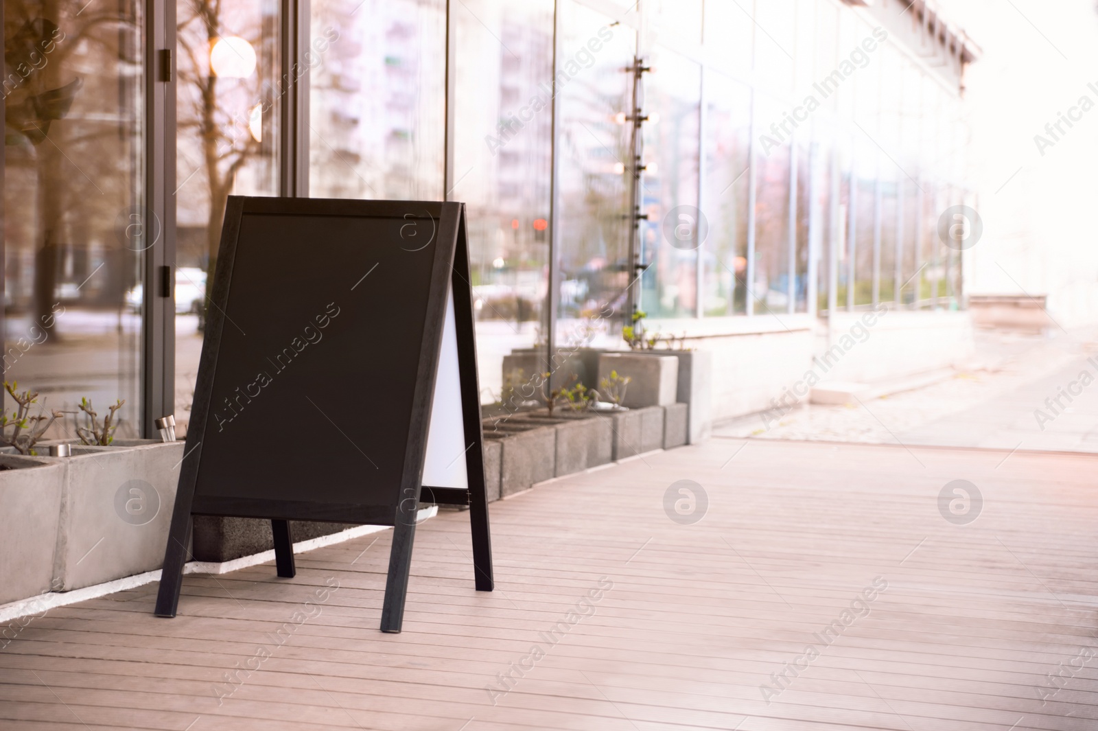 Photo of Empty A-board near building outdoors. Mockup for design