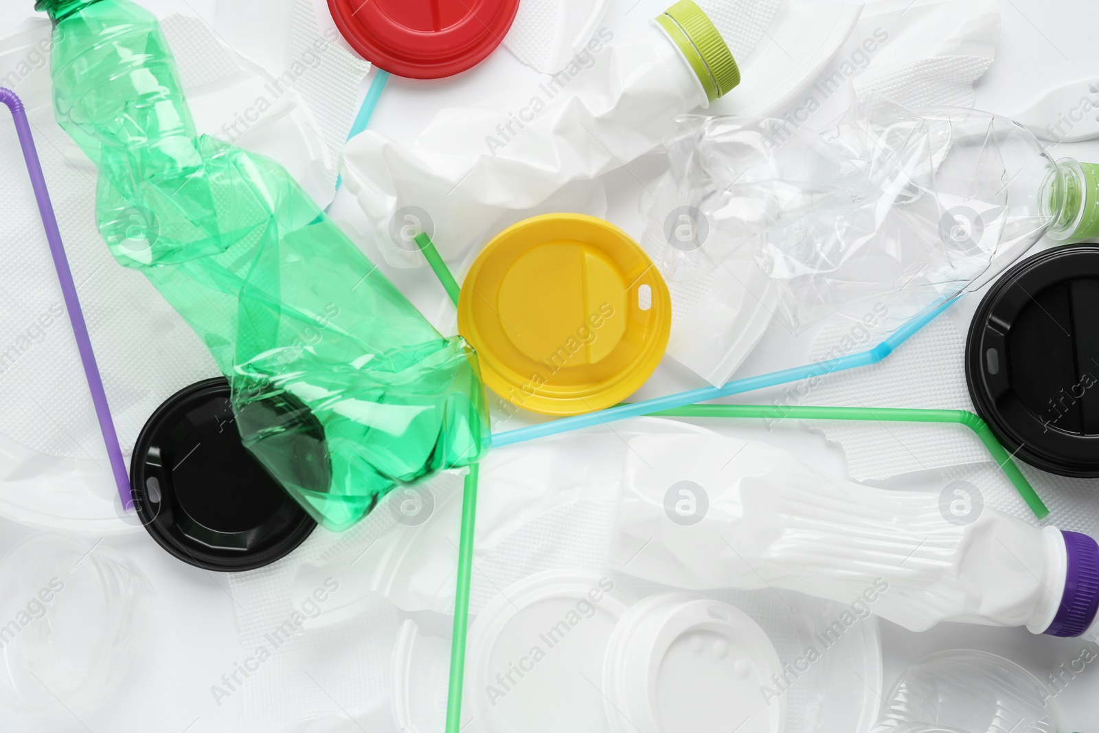 Photo of Pile of different plastic items as background, top view