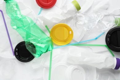 Pile of different plastic items as background, top view