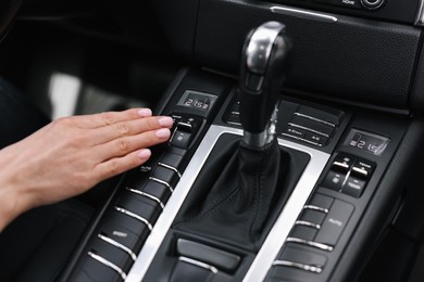 Woman using dashboard while driving her car, closeup