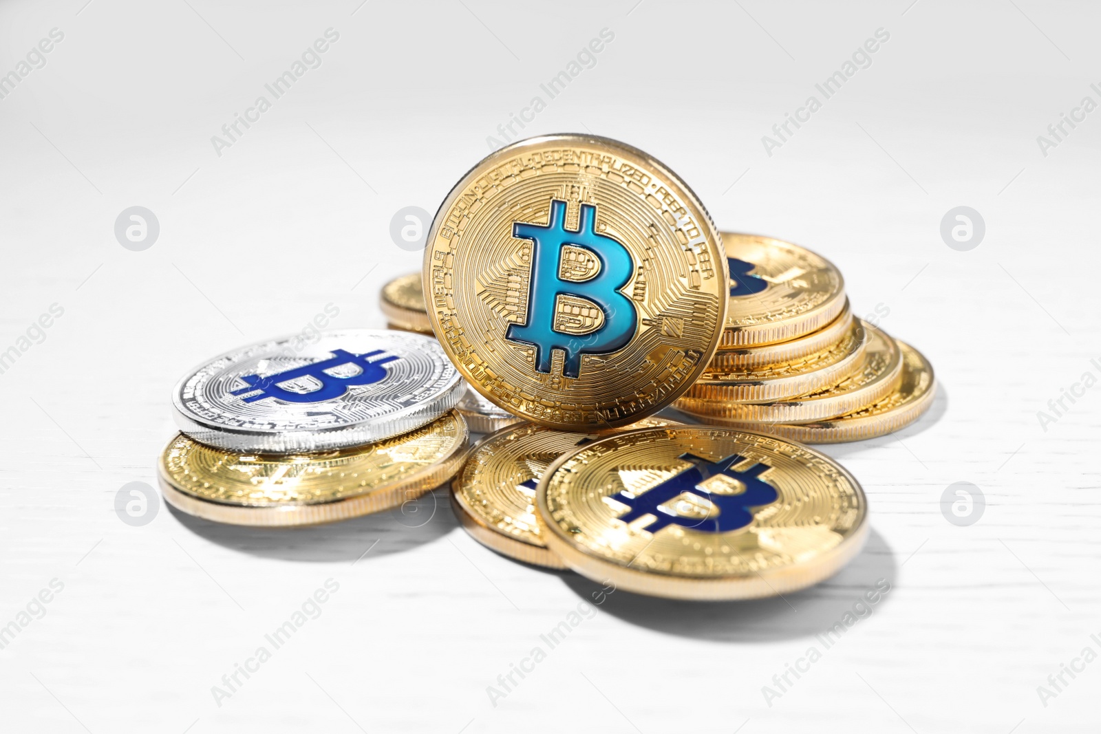Photo of Golden and silver bitcoins on wooden table, closeup. Digital currency