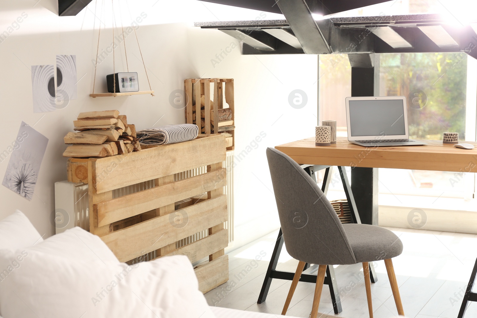 Photo of Elegant interior of room with workplace under stairs