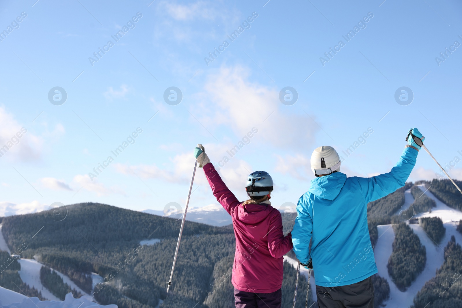 Photo of Couple with ski equipment spending winter vacation in mountains. Space for text