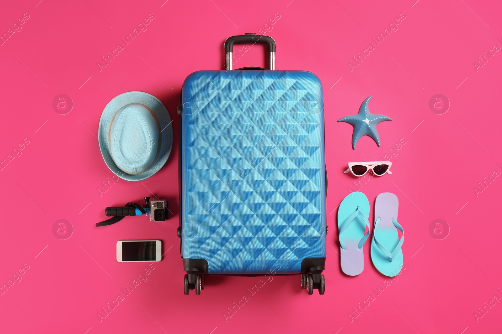 Photo of Flat lay composition with suitcase and traveler's accessories on color background