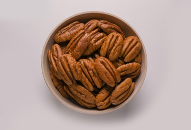 Tasty fresh ripe pecan nuts on white background, top view