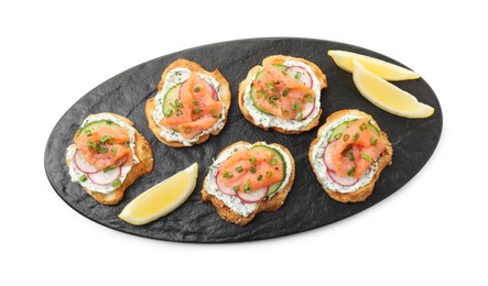 Photo of Tasty canapes with salmon, cucumber, radish and cream cheese isolated on white, top view