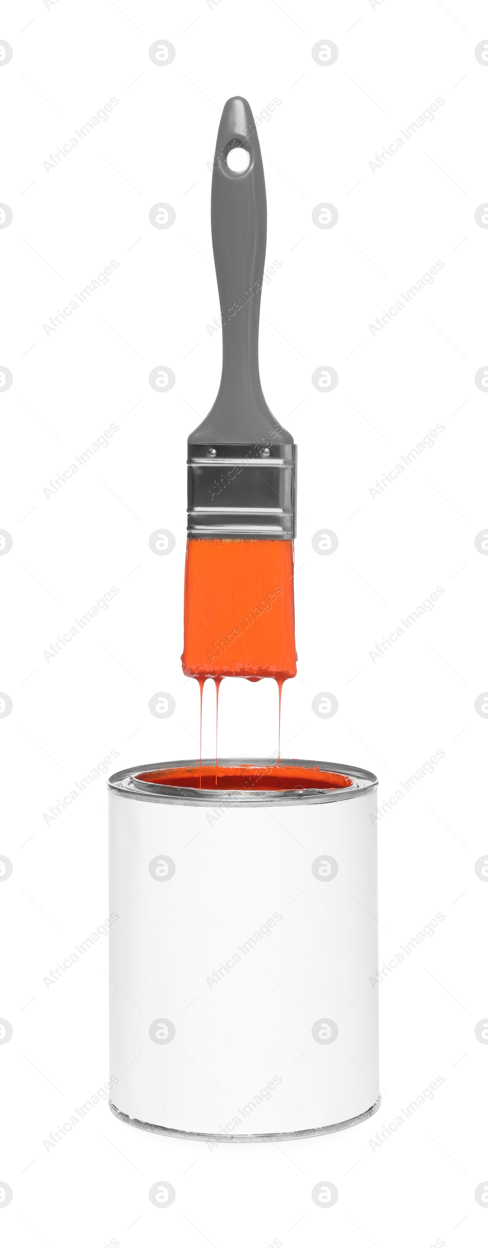 Image of Brush with orange paint in air over can on white background