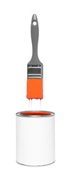 Image of Brush with orange paint in air over can on white background