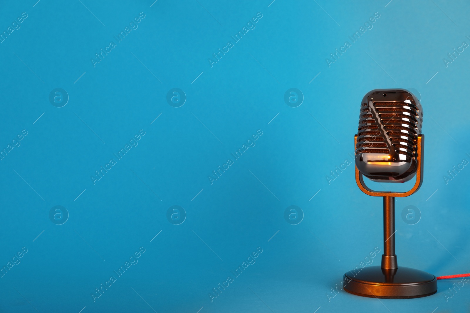 Photo of Retro microphone on color background. Space for text