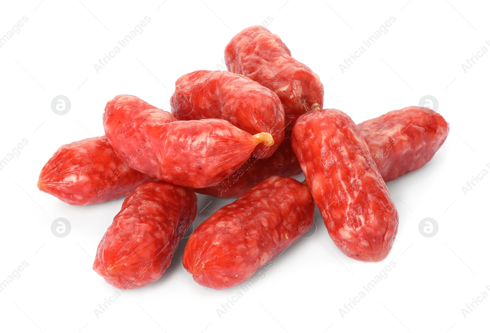 Photo of Many thin dry smoked sausages isolated on white