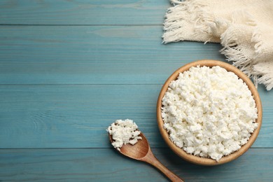 Photo of Delicious fresh cottage cheese on blue wooden table, flat lay. Space for text