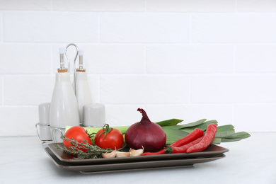 Fresh vegetables on white countertop in kitchen