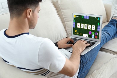 Image of Man playing poker on laptop at home. Casino online