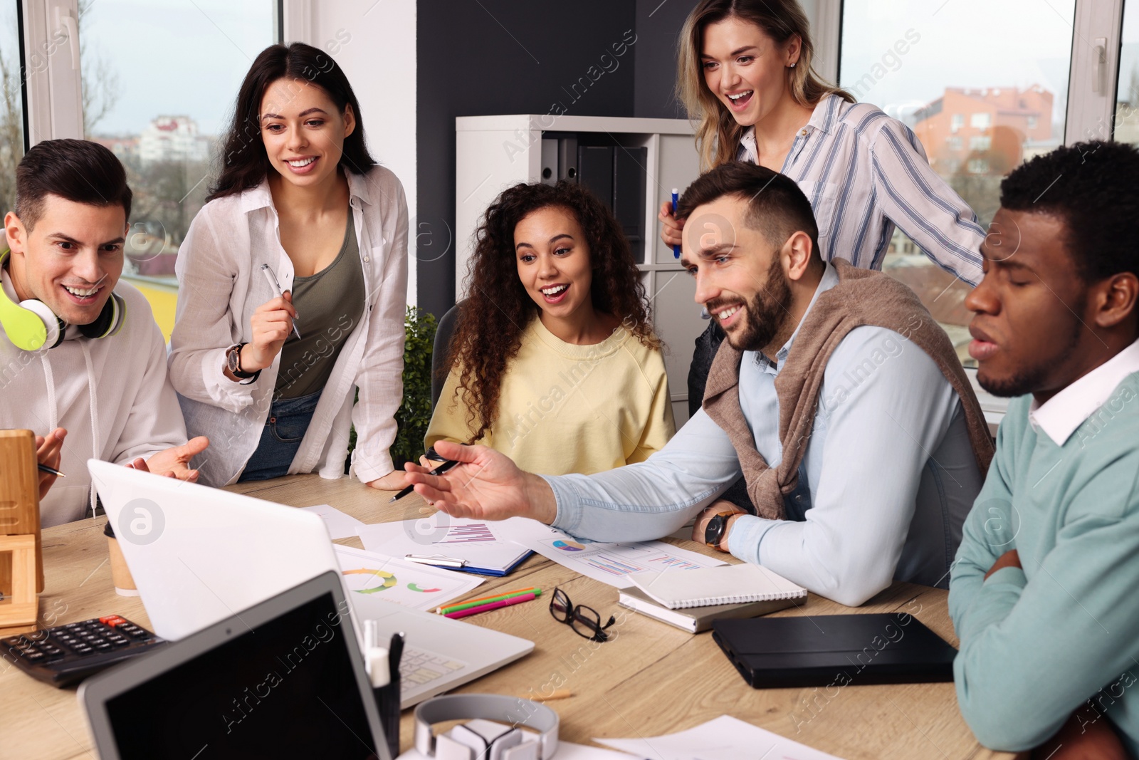 Photo of Team of employees working together in office. Startup project