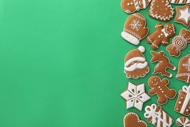 Photo of Different Christmas gingerbread cookies on green background, flat lay. Space for text