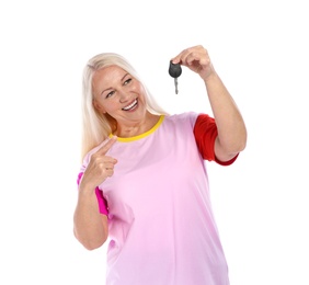 Happy mature woman with car key on white background. Getting driving license