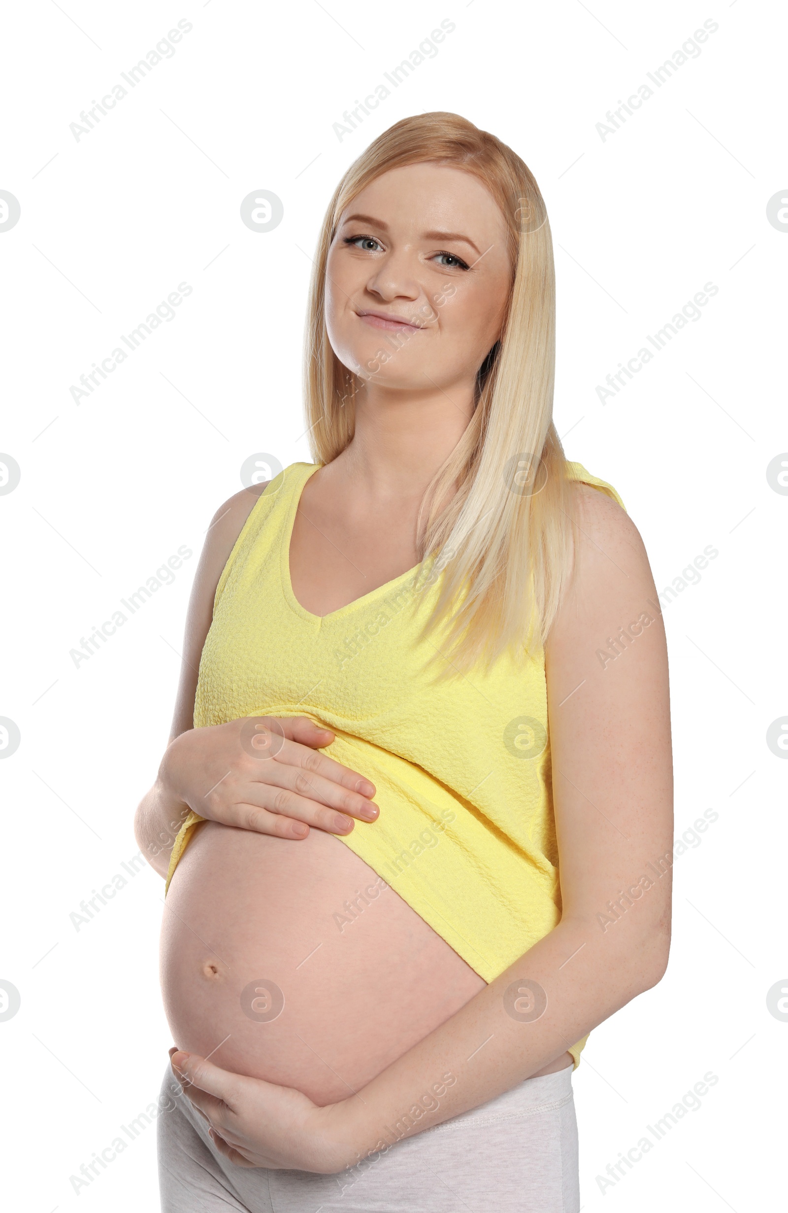 Photo of Beautiful pregnant woman showing her tummy on white background