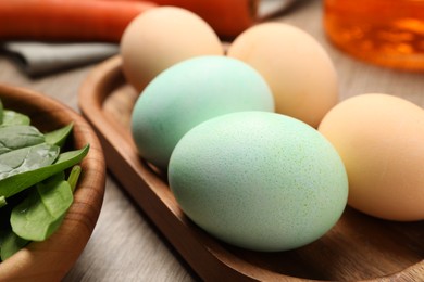 Naturally painted Easter eggs on wooden table, closeup. Spinach used for coloring