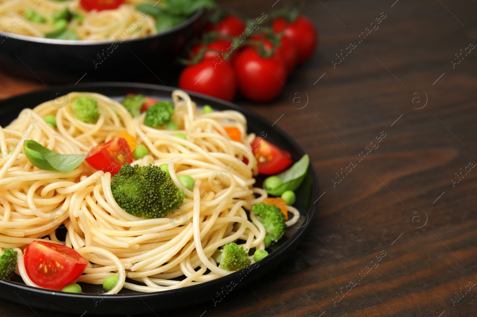 Photo of Plate of delicious pasta primavera on wooden table, closeup