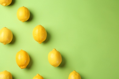 Flat lay composition with fresh ripe lemons on color background