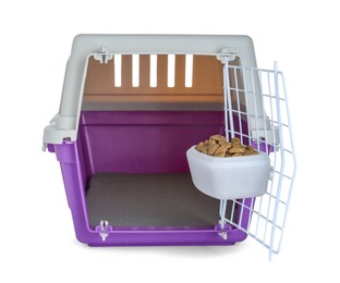 Photo of Violet pet carrier with bowl of dry food isolated on white