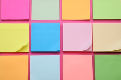 Colorful empty notes on pink background, flat lay