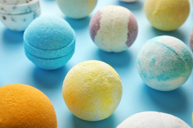 Photo of Many different bath bombs on color background