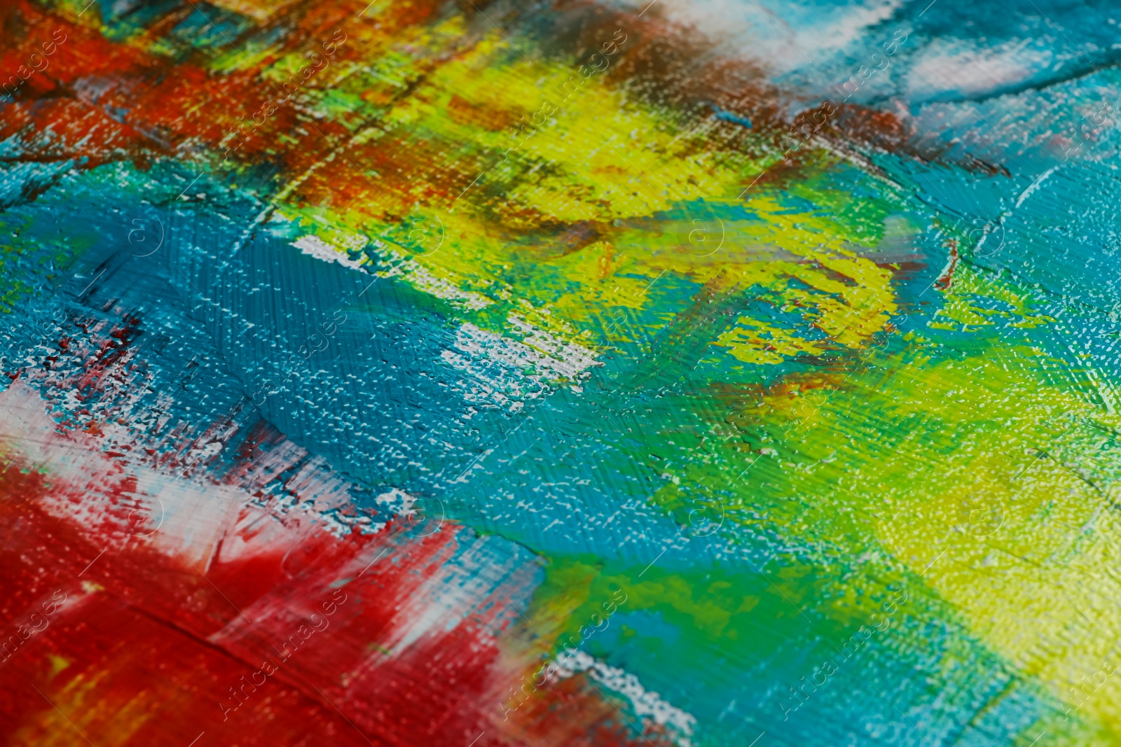 Photo of Strokes of colorful acrylic paints on canvas, closeup