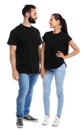 Photo of Young couple in t-shirts on white background. Mockup for design