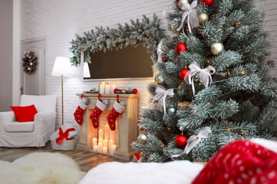 Photo of Beautiful decorated Christmas tree in living room interior