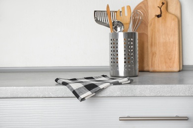 Photo of Fabric checkered towel on table in kitchen