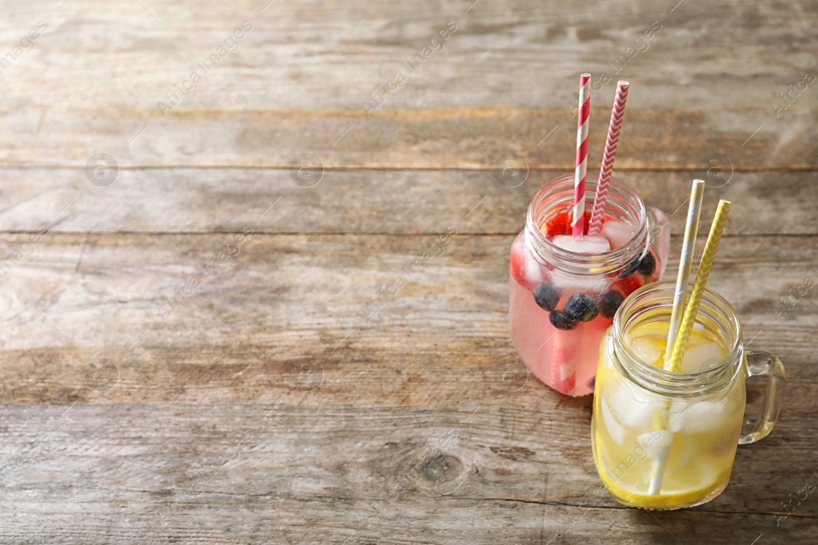 Photo of Natural lemonades in mason jars on wooden table