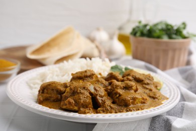 Photo of Delicious chicken curry with rice on table, closeup