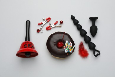 Photo of Flat lay composition with sex toys on white background