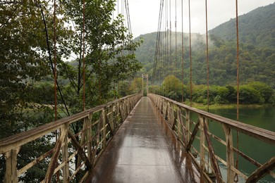 Beautiful view on rusty metal bridge over river in mountains