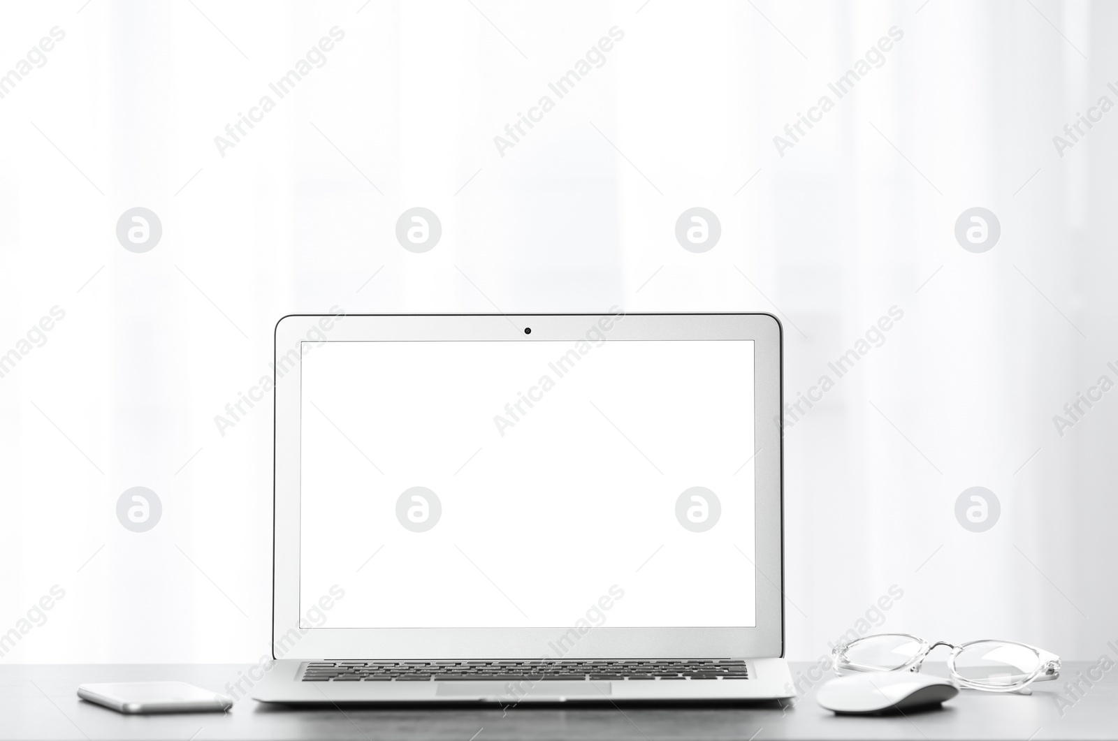 Photo of Laptop on desk in home office. Comfortable workplace