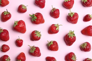 Photo of Tasty ripe strawberries on pink background, flat lay